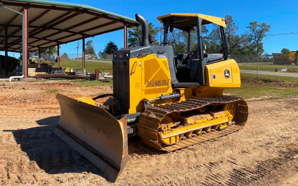 yellow construction machine picking some dirt